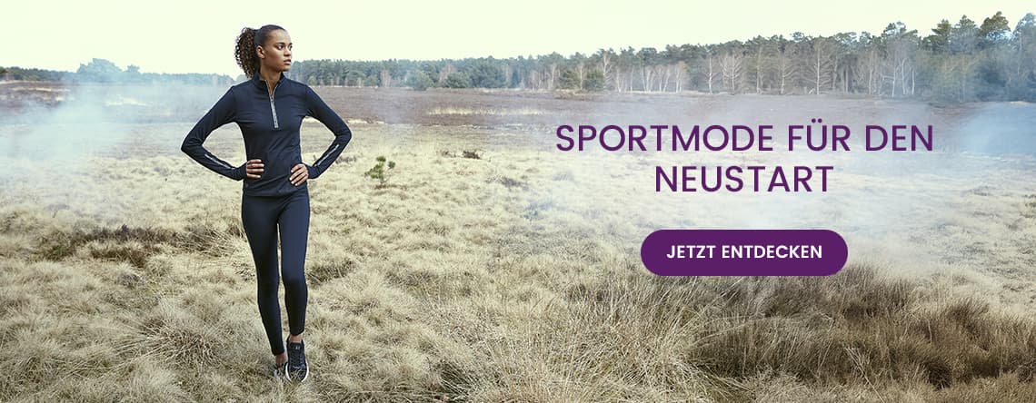 SPORTMODE FÜR DEN NEUSTART – Frau in dunkler Sportkleidung steht auf einer Wiese. JETZT ENTDECKEN