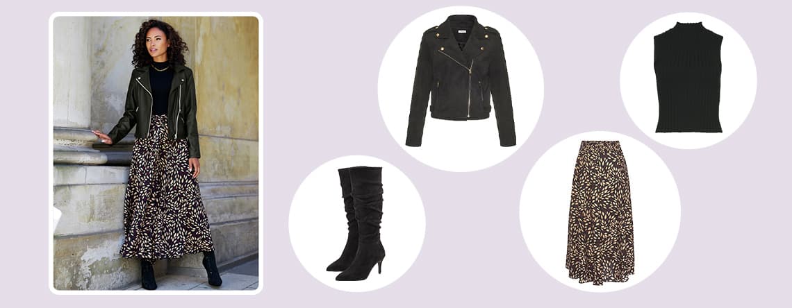 Frau in gemustertem Rock mit schwarzer Lederjacke und Stiefeln lehnt an Wand. Daneben schwarze Lederjacke, Stiefel, Rock und Top.